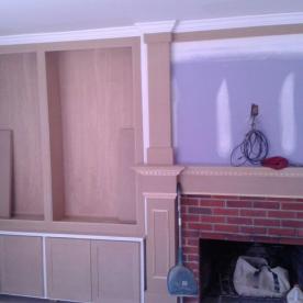Custom bookcases and storage cabinets to compliment modernization of old brick fireplace
