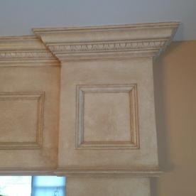 Custom trim and paneled archway with egg and dart and crown molding with faux paint effect