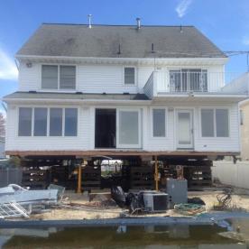House elevation lifting rear yard view