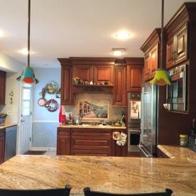 Cherry raised paneled cabinets with granite countertops