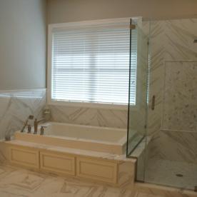 Platform tub with frameless glass shower