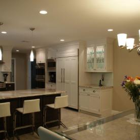 Refrigerator wall with lighted upper display cabinet