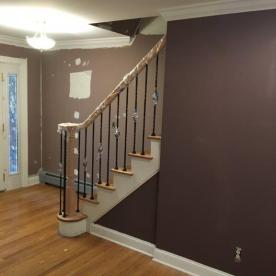 Whole house renovation, stair railing modernization underway with metal balusters
